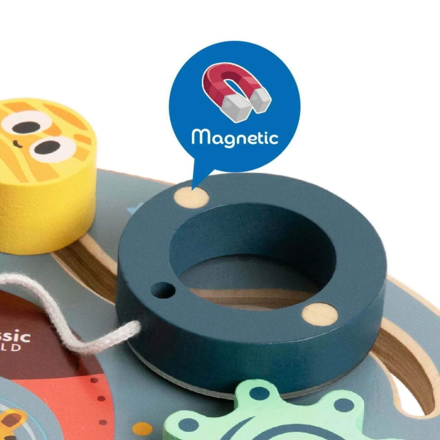 Close-up of the magnetic ring feature on a wooden busy board, shown detached with a magnet symbol.