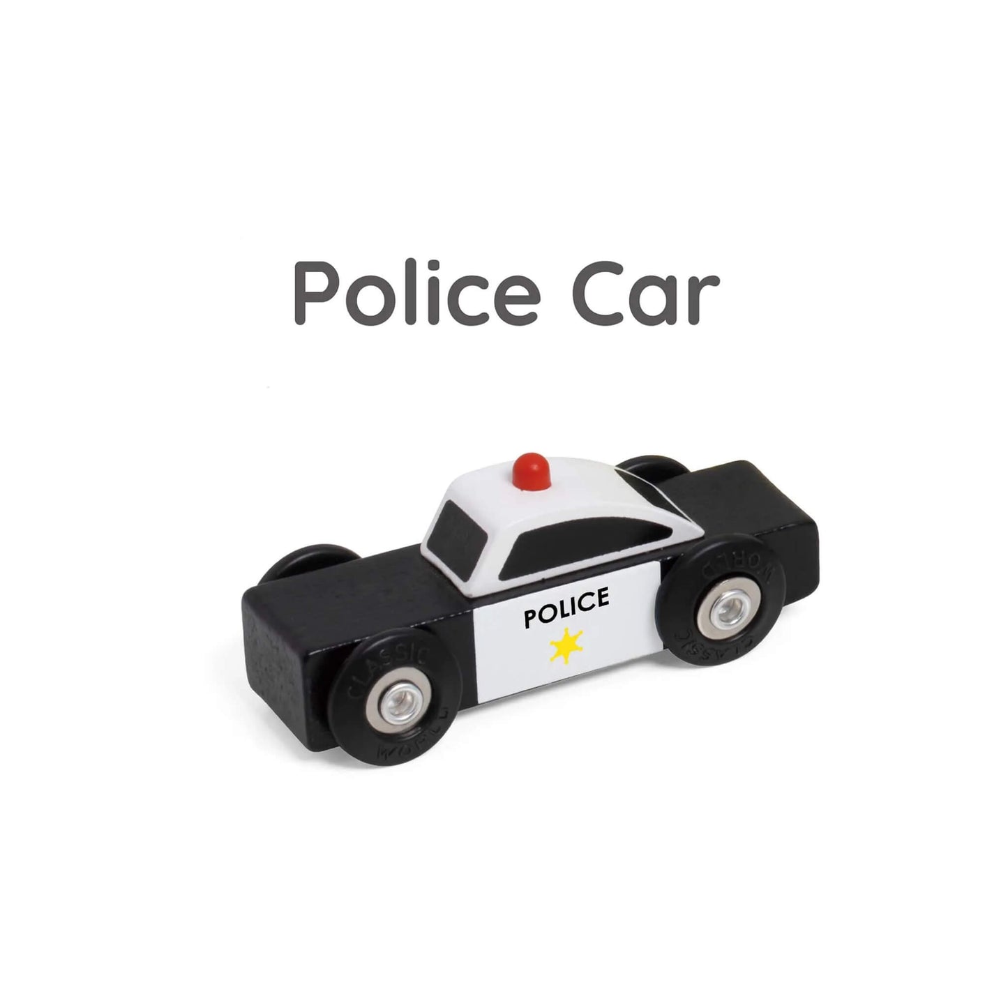 Close-up of black and white wooden toy police car with red light on top and star badge detail on the side.