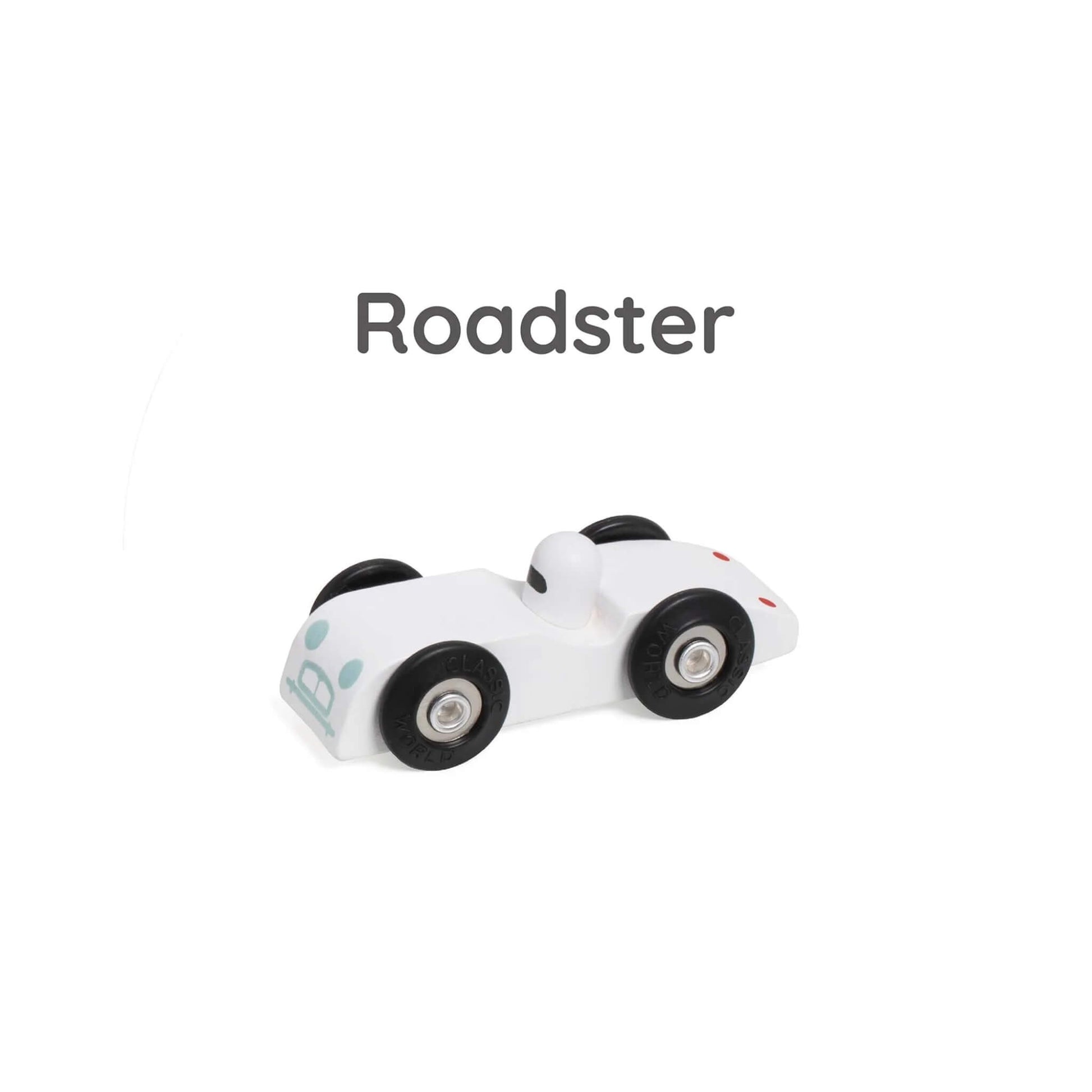 White wooden toy roadster named Roadster, with black wheels and a small white driver figure.