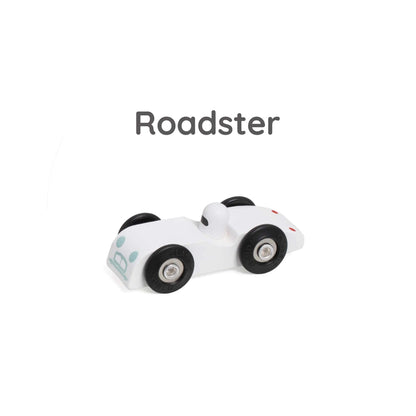 White wooden toy roadster named Roadster, with black wheels and a small white driver figure.