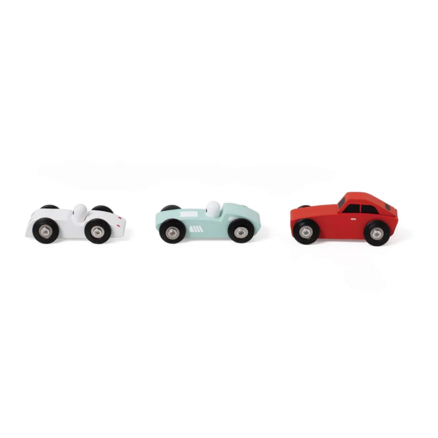 Three wooden toy cars lined up side by side — white roadster, pale blue racer, and red coupe, all with black wheels.