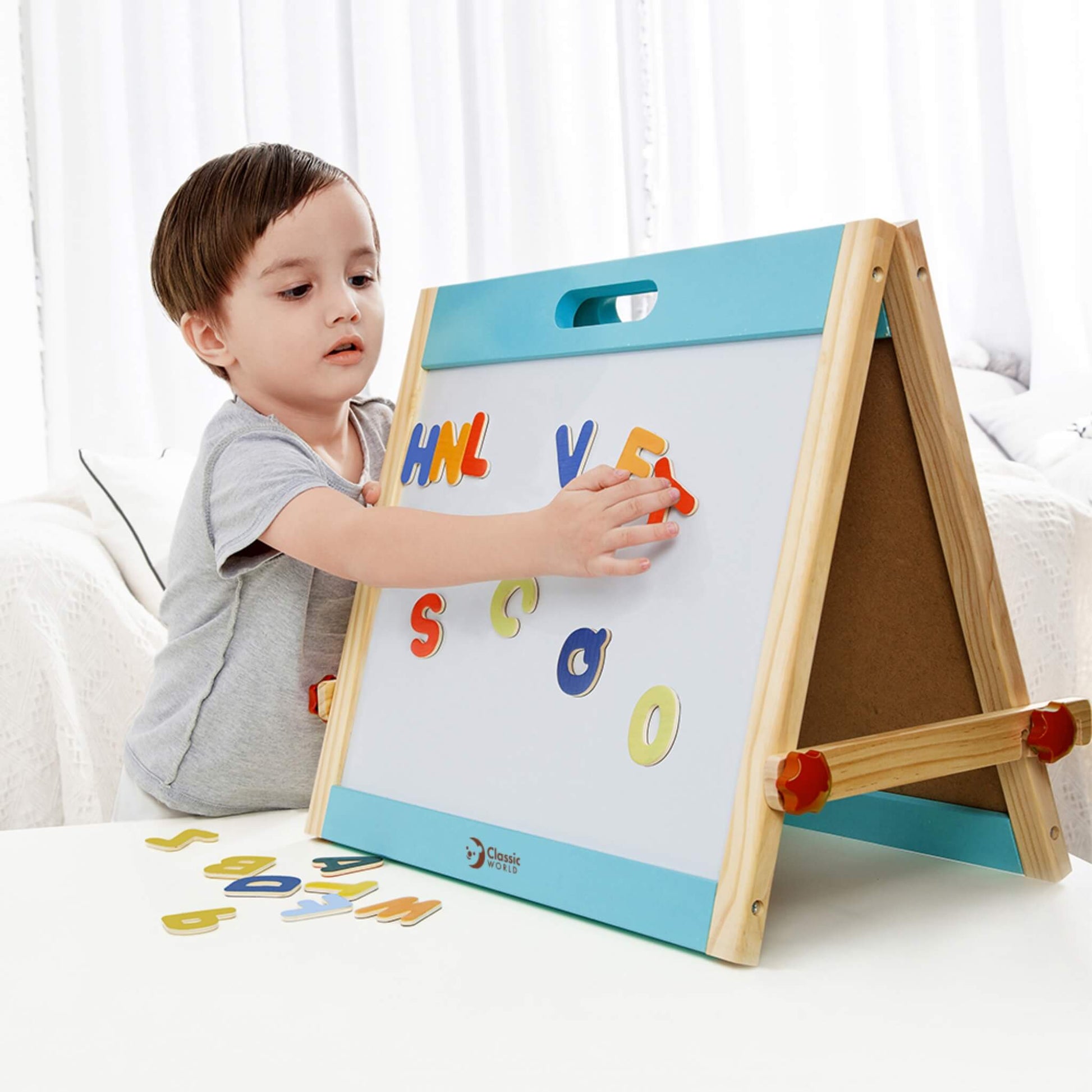 Child using wooden tabletop easel with magnetic letters, supporting early literacy skills and independent learning through play.