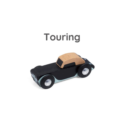 Close-up of black wooden toy convertible labelled “Touring” above, showing natural wood roof and soft blue trim.