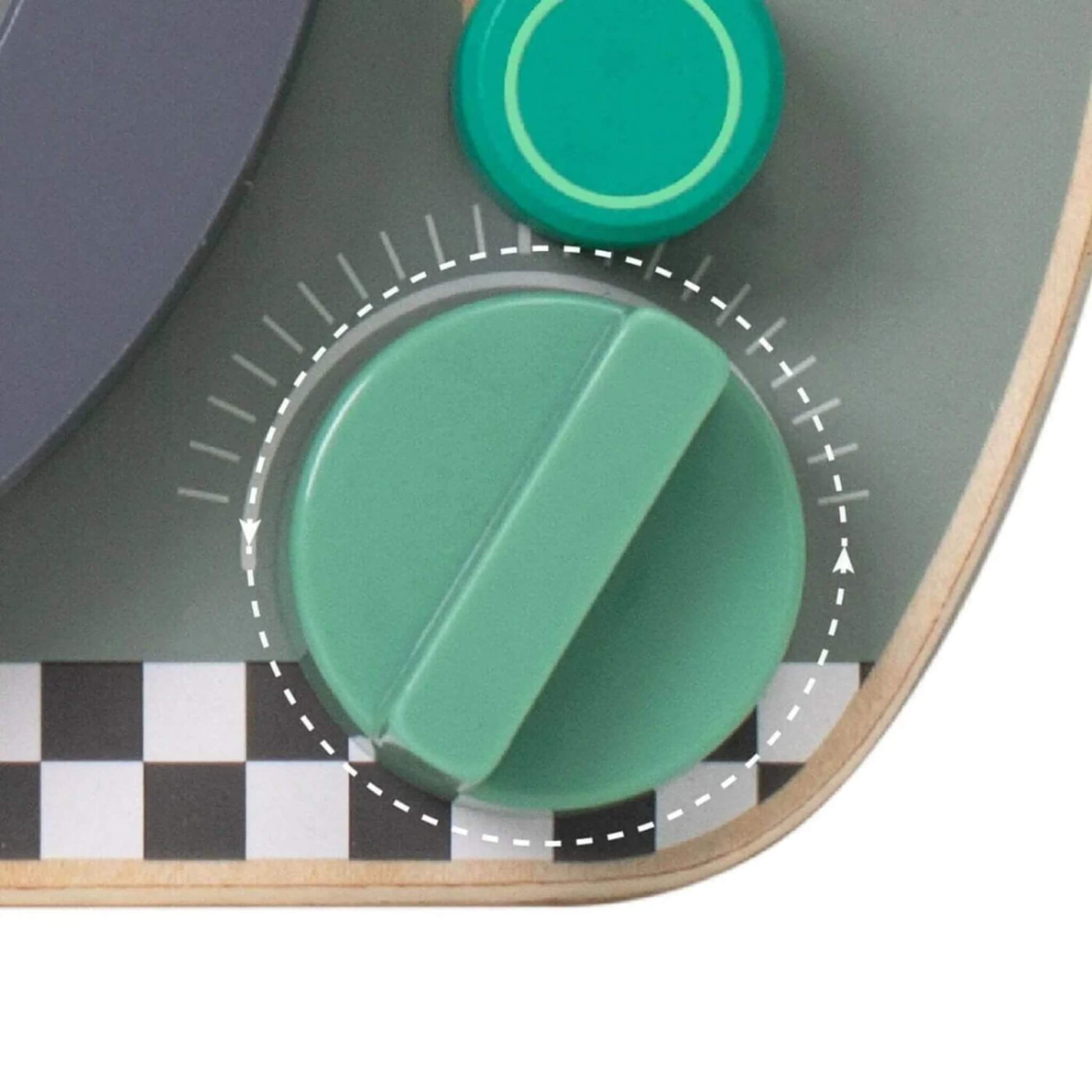 Close-up of green spinning dial and knob on a wooden busy board with checkered detailing.