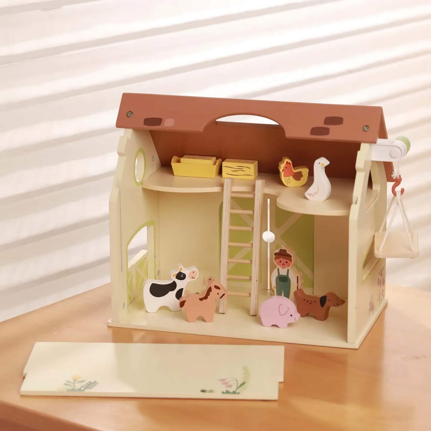 Open wooden barn playset with ladder, loft, animals and figures set up inside farm scene.