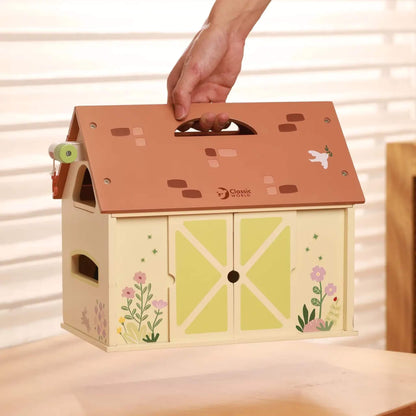 Portable wooden toy barn with carry handle and opening doors designed for easy storage and transport.