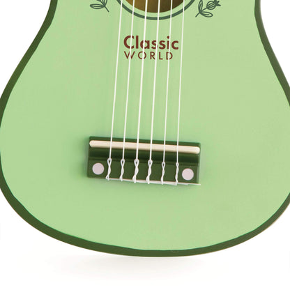 Close-up of a wooden vintage-style classic kids guitar's bridge and strings, showcasing its green finish and child-friendly design.