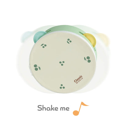 A children's wooden tambourine featuring a soft cream top with green cherry patterns, perfect for musical play.