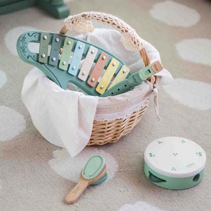 the wooden Classic World Vintage-style Music Set displayed in a woven basket with xylophone, recorder, tambourine, and maracas, perfect for musical exploration.