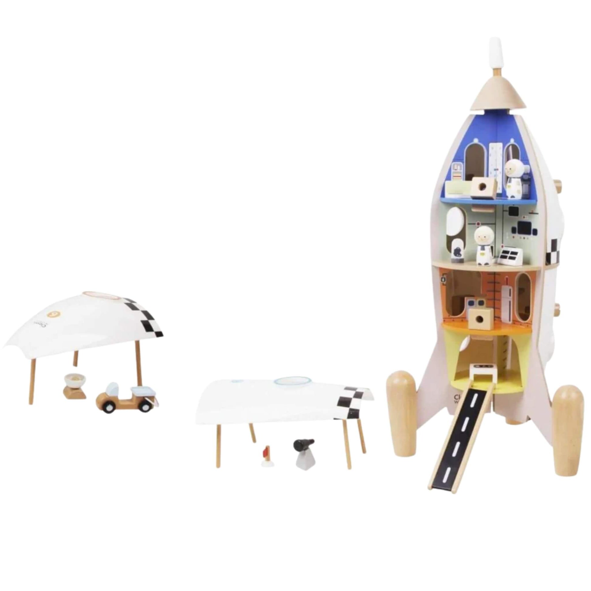 A tall wooden rocket playset split open to reveal four levels inside, including astronaut figures, control rooms, a ramp, and detachable roof sections displayed nearby on the ground.
