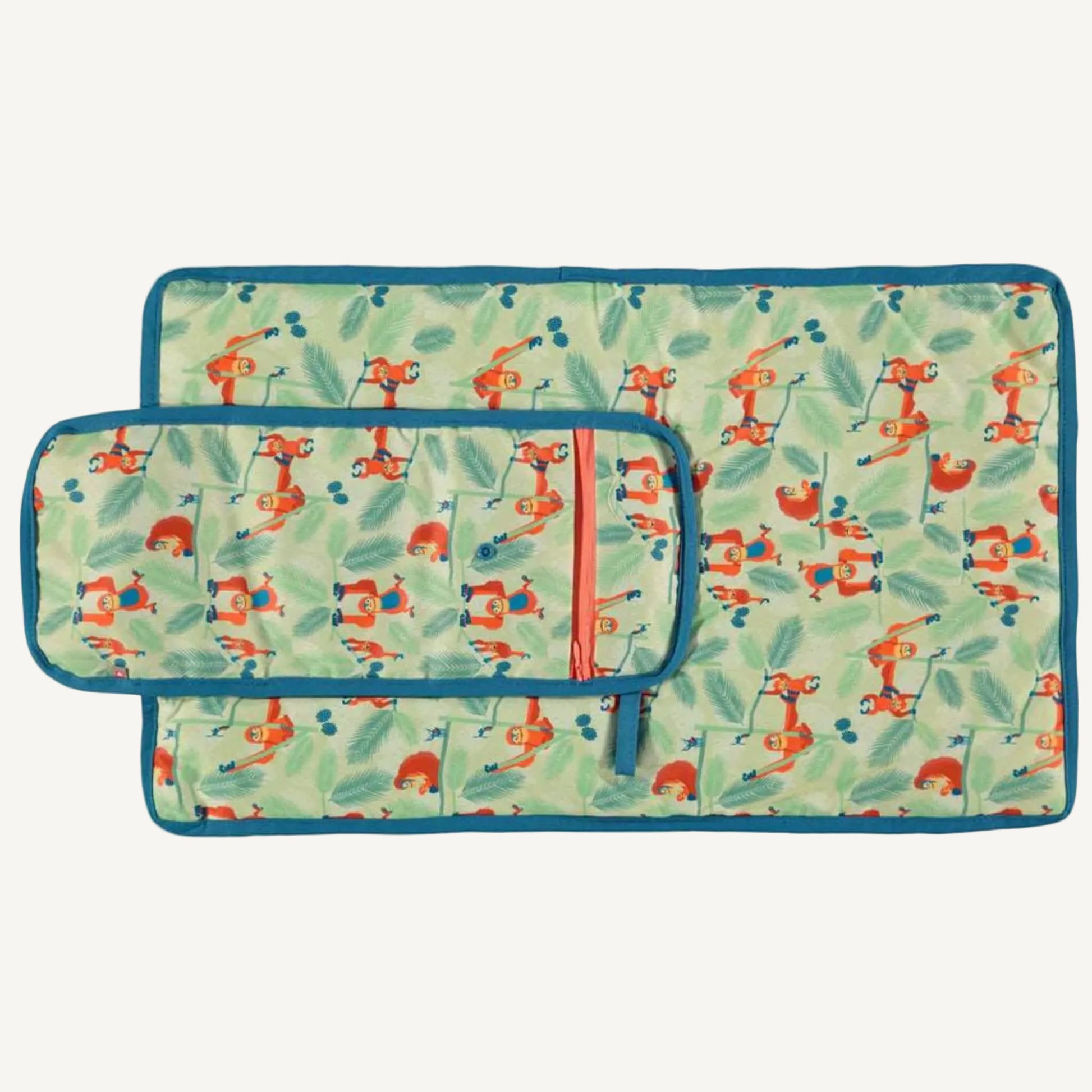 A changing mat laid flat with the printed side facing up, showing the full orangutan pattern across the surface.