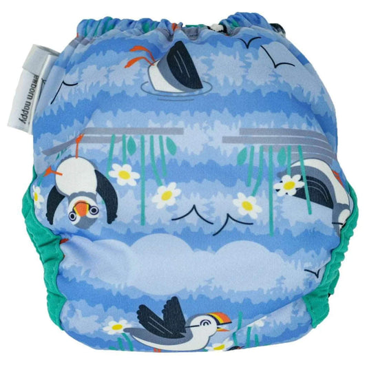 A newborn reusable nappy shown from the back with gathered elastic and a blue puffin-themed print featuring birds, clouds and flowers.