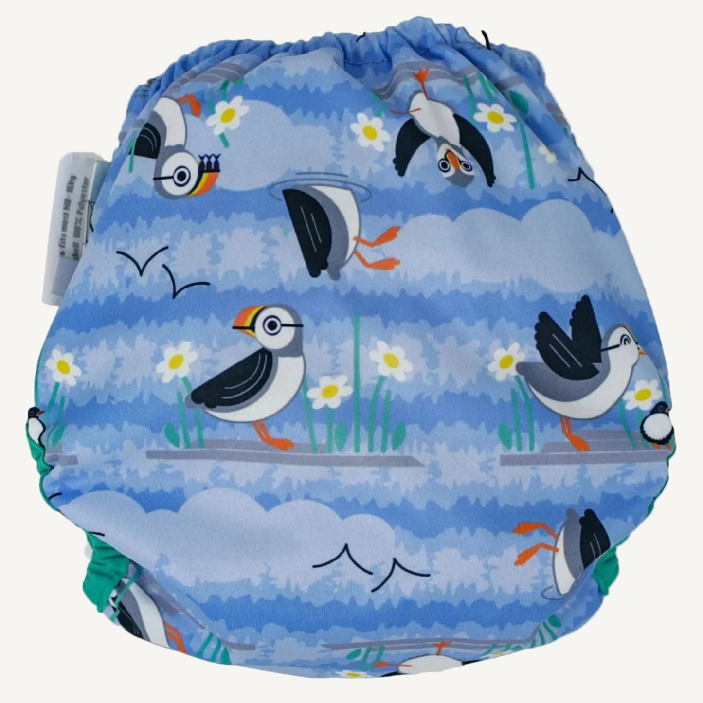 A reusable nappy cover shown from the back, with a light blue illustrated puffin print and soft green edging along the leg openings and waistband.