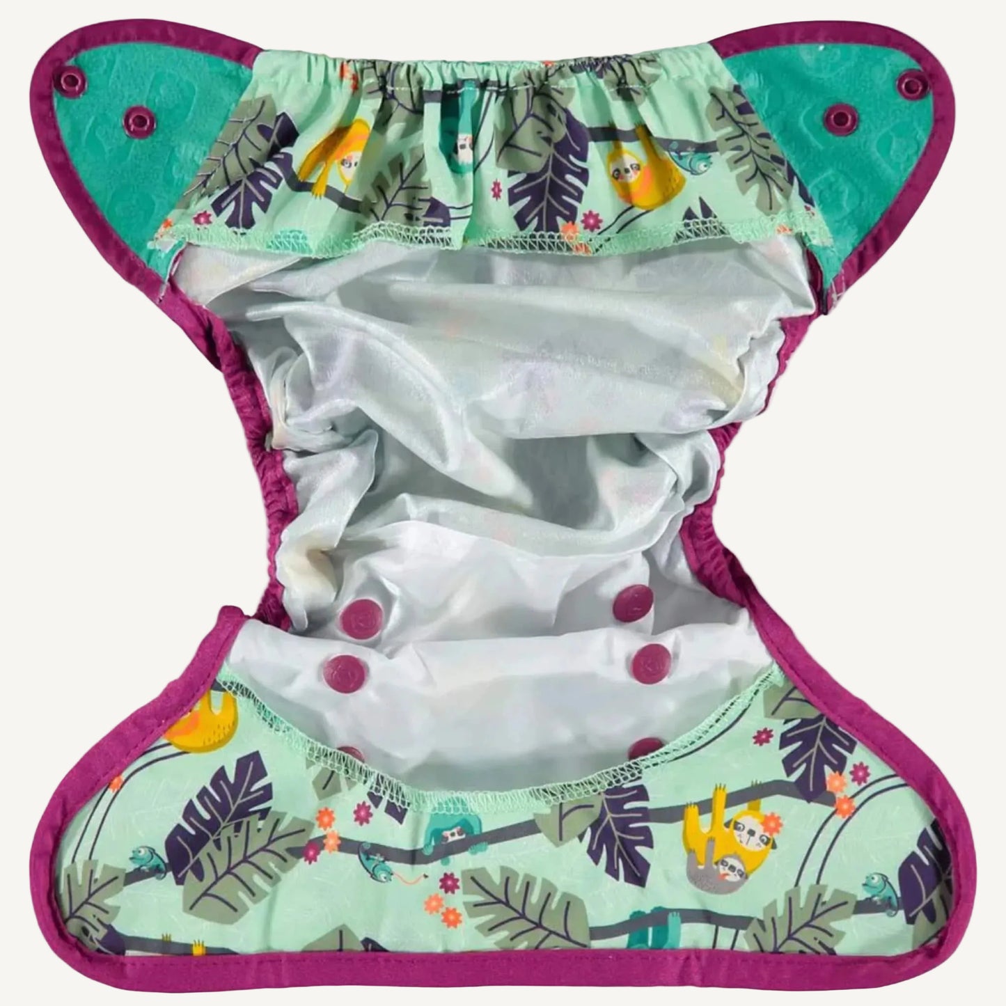 Inside view of a reusable nappy cover laid flat, showing the white waterproof inner fabric and elasticated leg gussets.