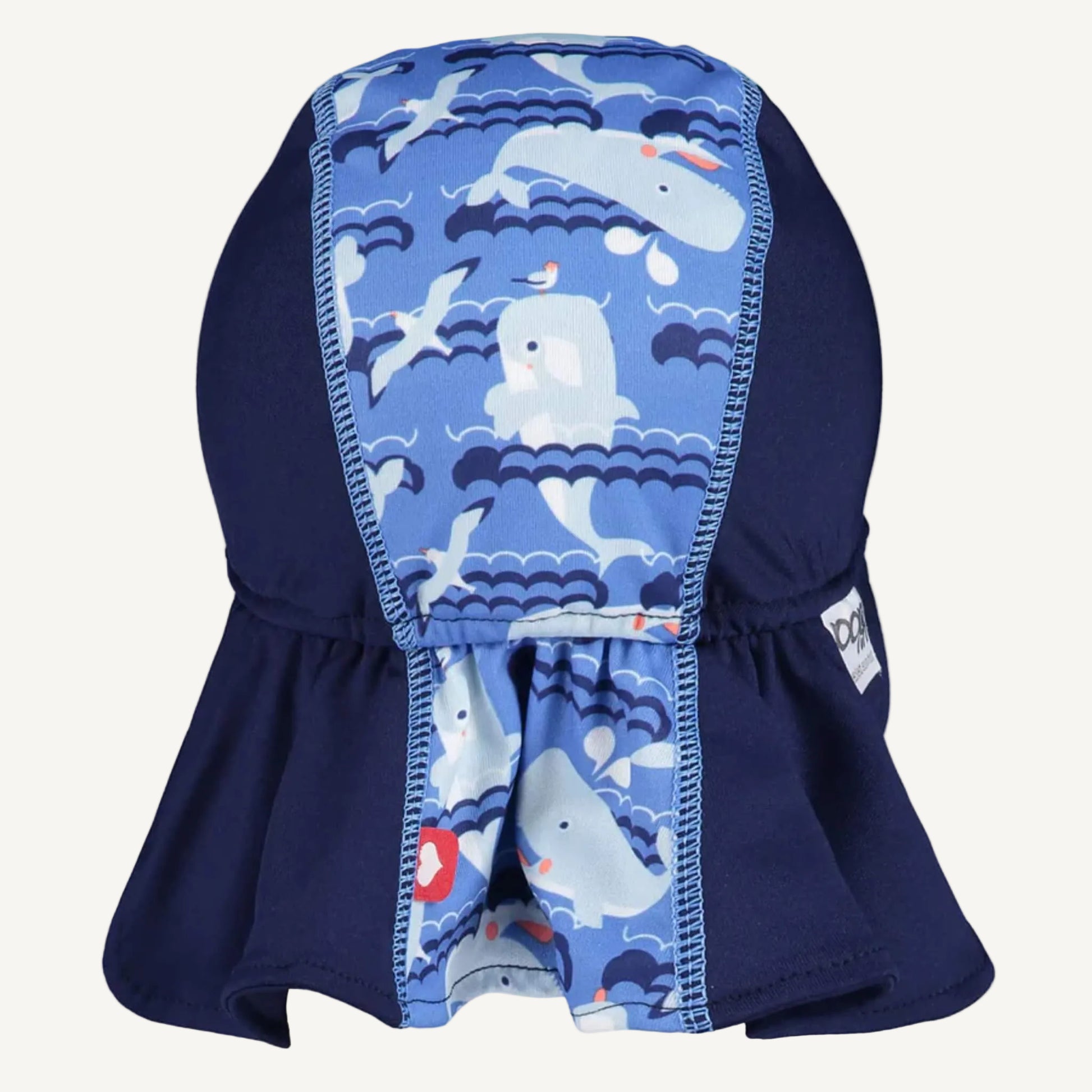 A toddler sun hat shown from the back with a central whale-patterned panel and a wide extended neck cover in deep navy.