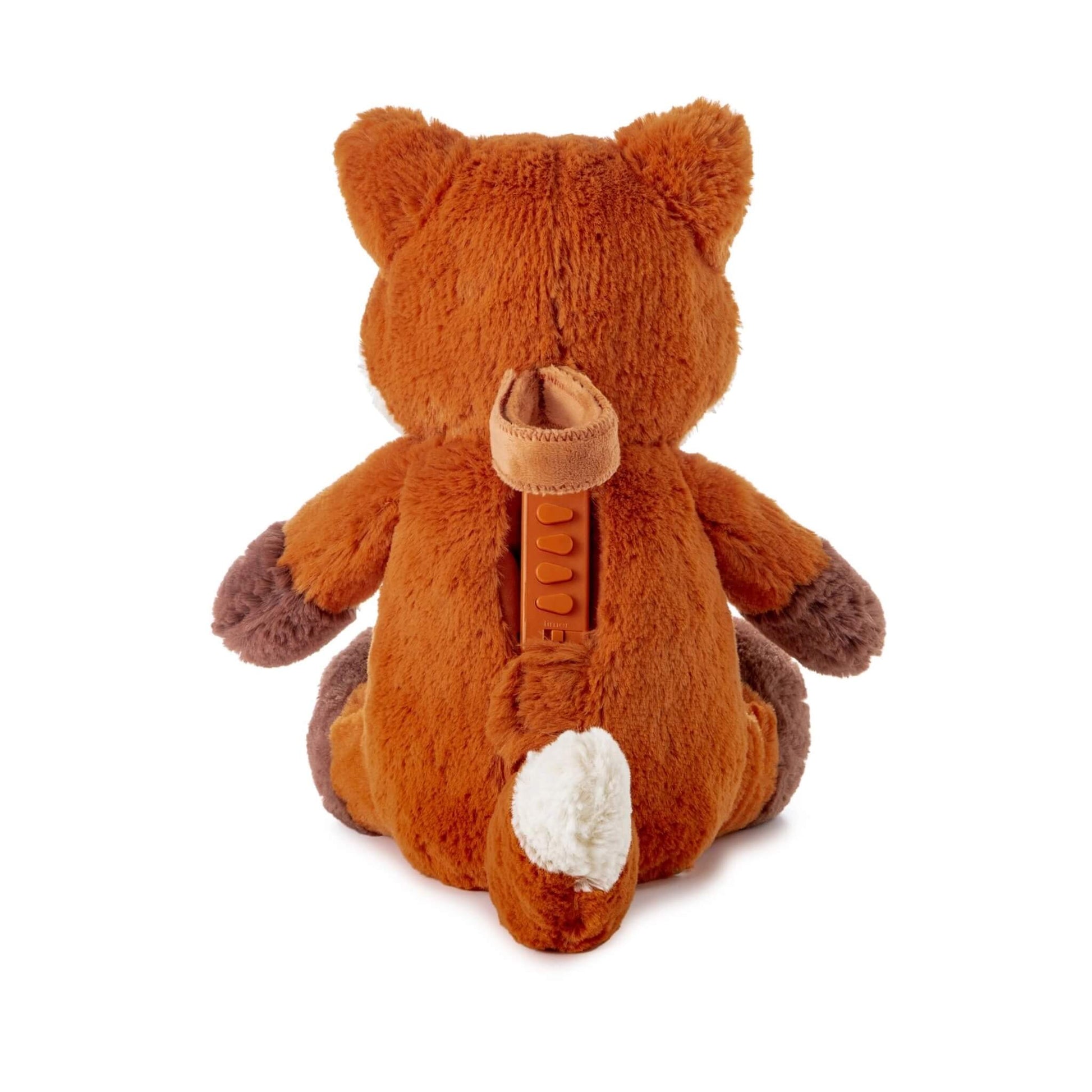 Back view of plush fox toy showing fabric compartment with secure strap and inserted sound module in orange, alongside a white tip on its tail.