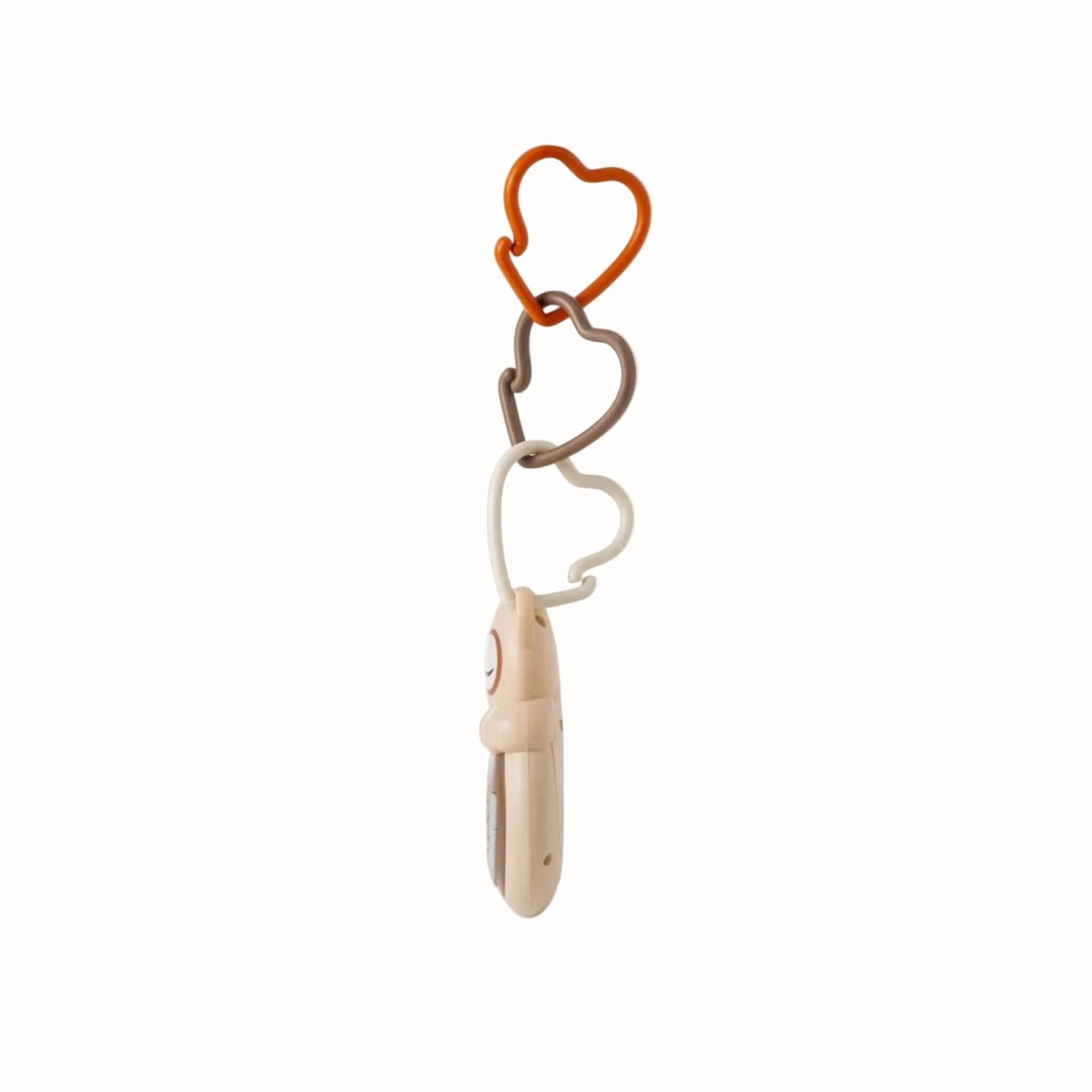 Side view of an owl-shaped portable baby sound machine showing its slim profile and attachment links