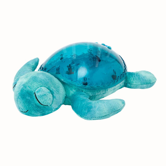 A soft turquoise turtle nightlight with a rounded translucent aqua shell, closed embroidered eyes, four plush flippers and a small smiling face.