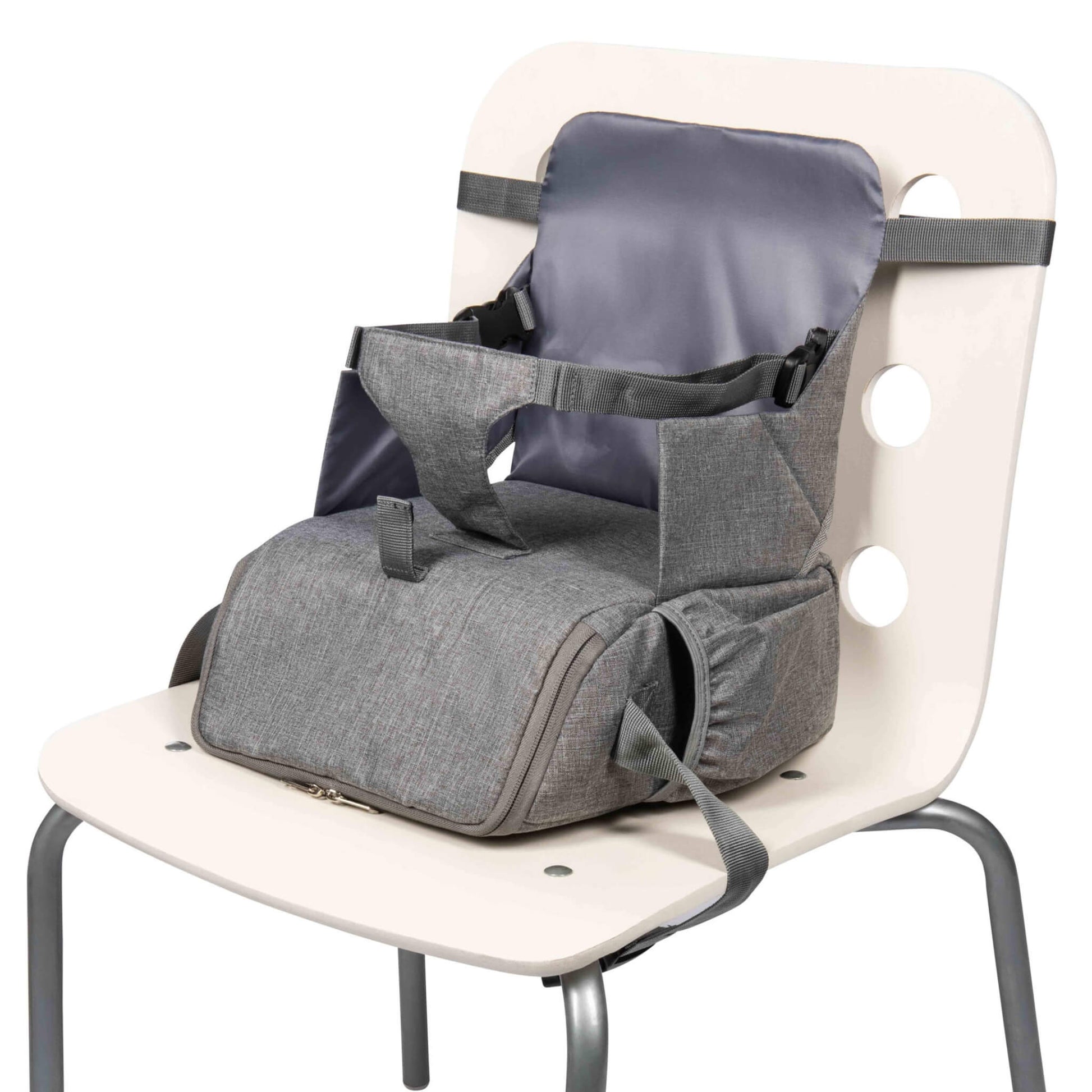 A grey booster seat securely fastened to a white chair without a child in it.