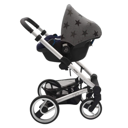 A grey stars print car seat hoody attached to an infant car seat placed on a silver pushchair frame, showing how it fits with a travel system.