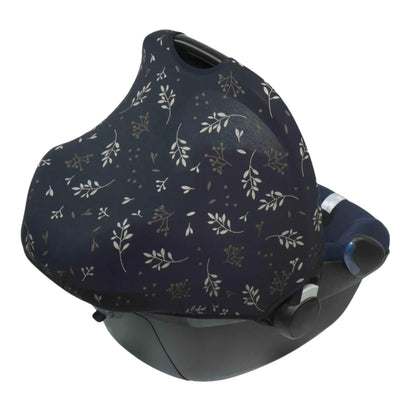 A black and beige leaf patterned car seat hoody fully extended over an infant car seat, covering the seat to create a private and shaded space.