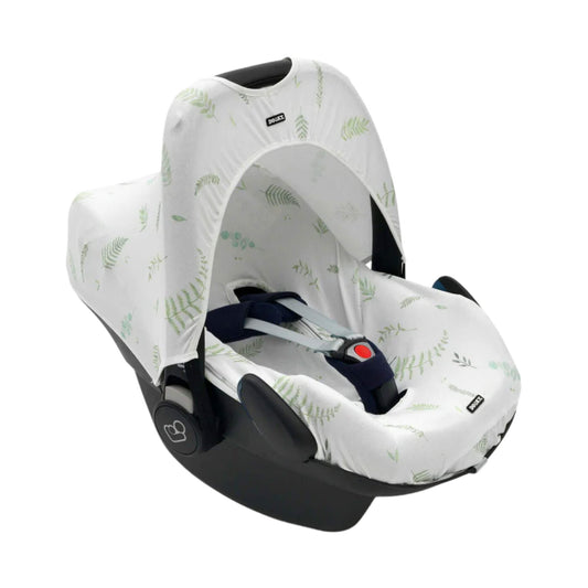 A Dooky Car Seat Hoody in a white fabric with soft green leaf prints fitted to a navy infant car seat, providing shade and UV protection.