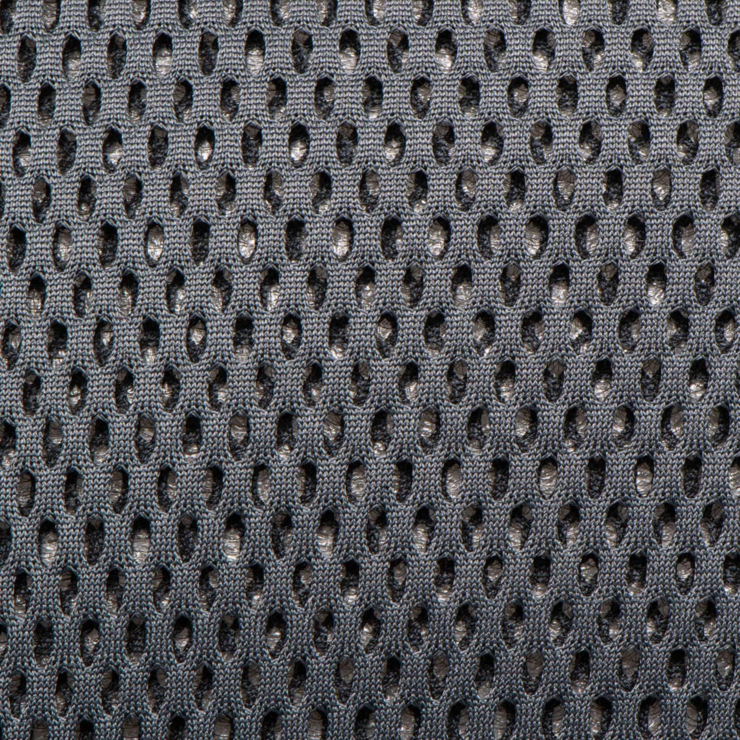 Close-up of grey breathable mesh fabric used on a baby carrier.