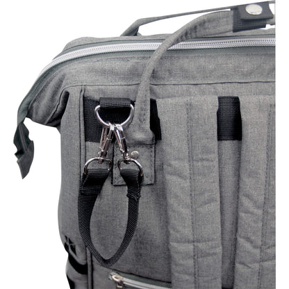 A close-up of a D-ring and two metal clips attached to a fabric loop near the back straps of a changing bag, designed for securing or hanging accessories.