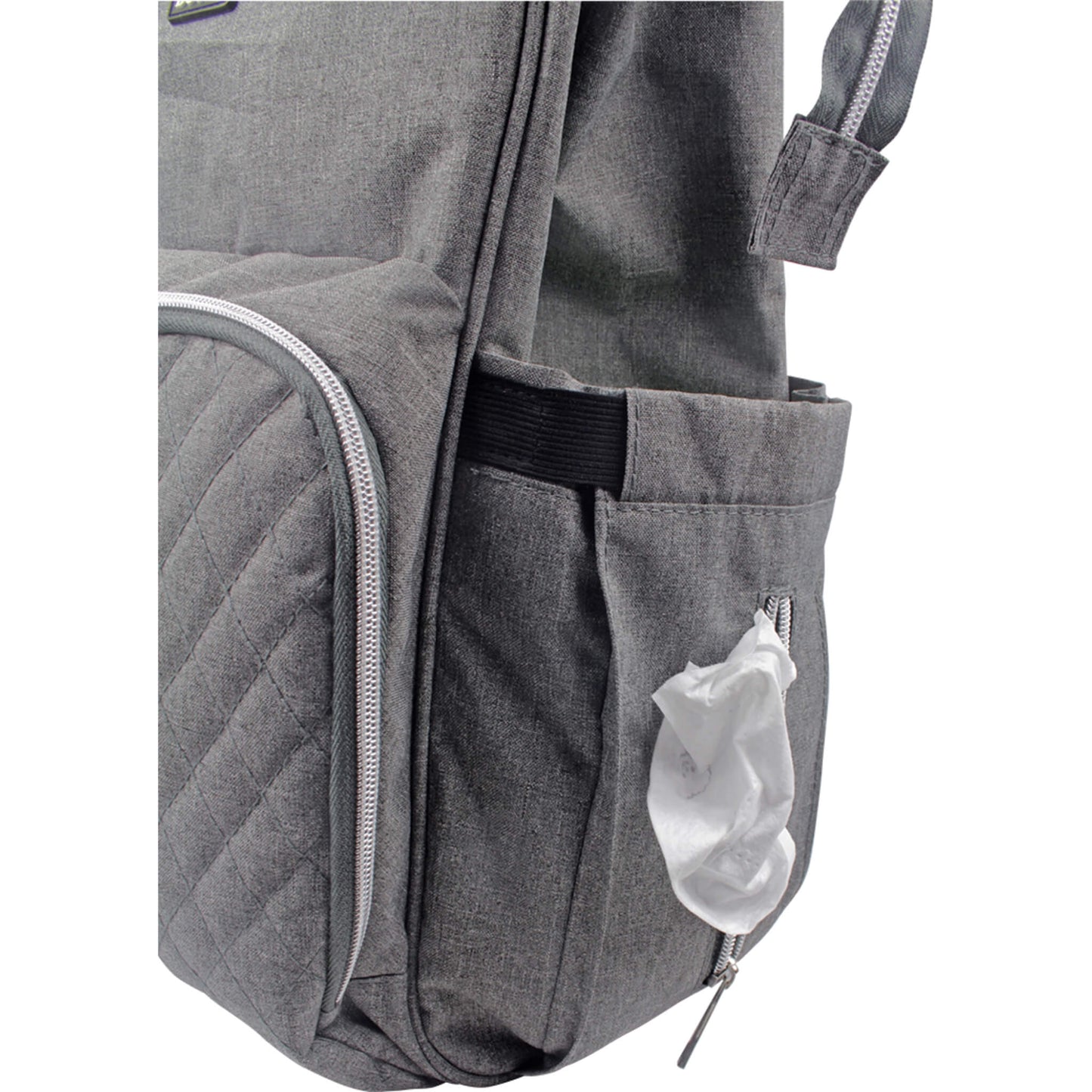 A close-up of a side pocket on a changing bag with a zipped opening for tissues or wet wipes, showing one wipe partially pulled through.