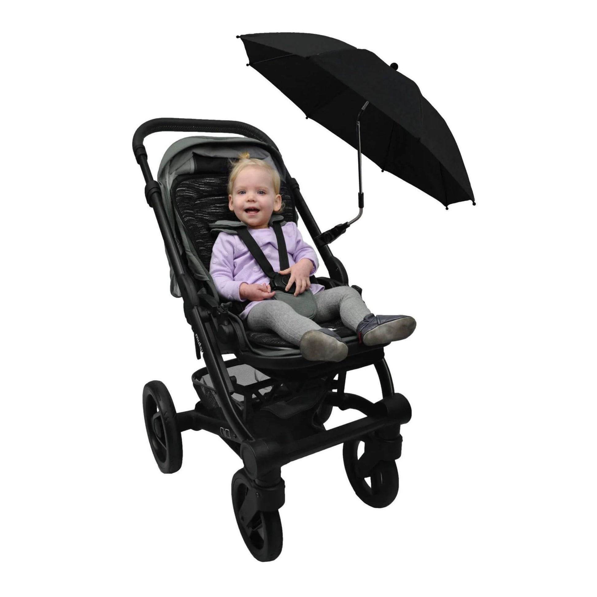 A toddler smiling while seated in a stroller with the parasol angled to the side for sun protection.