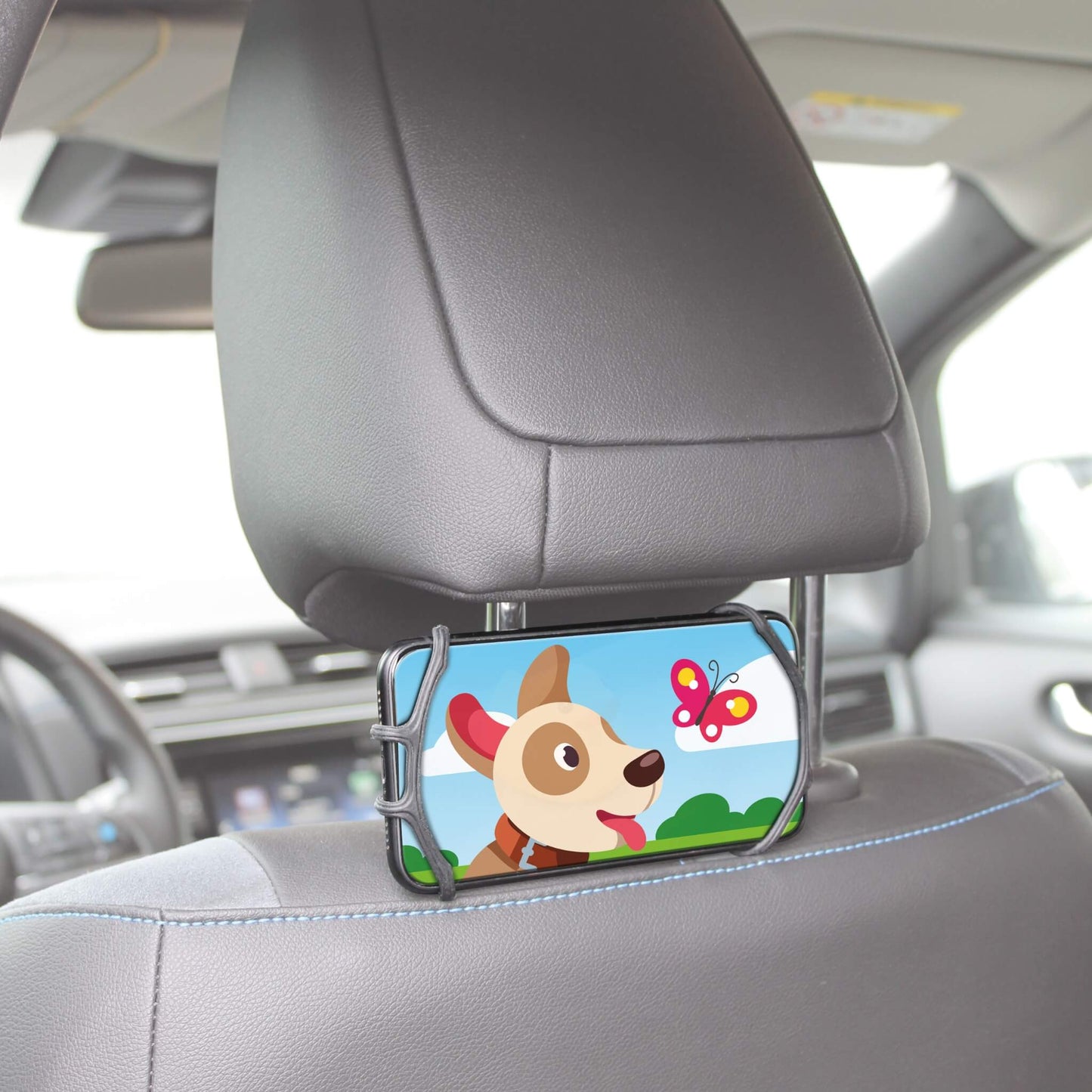 A car phone holder clip mounted on a gray car headrest, holding a smartphone with a colorful cartoon dog and butterfly screen.