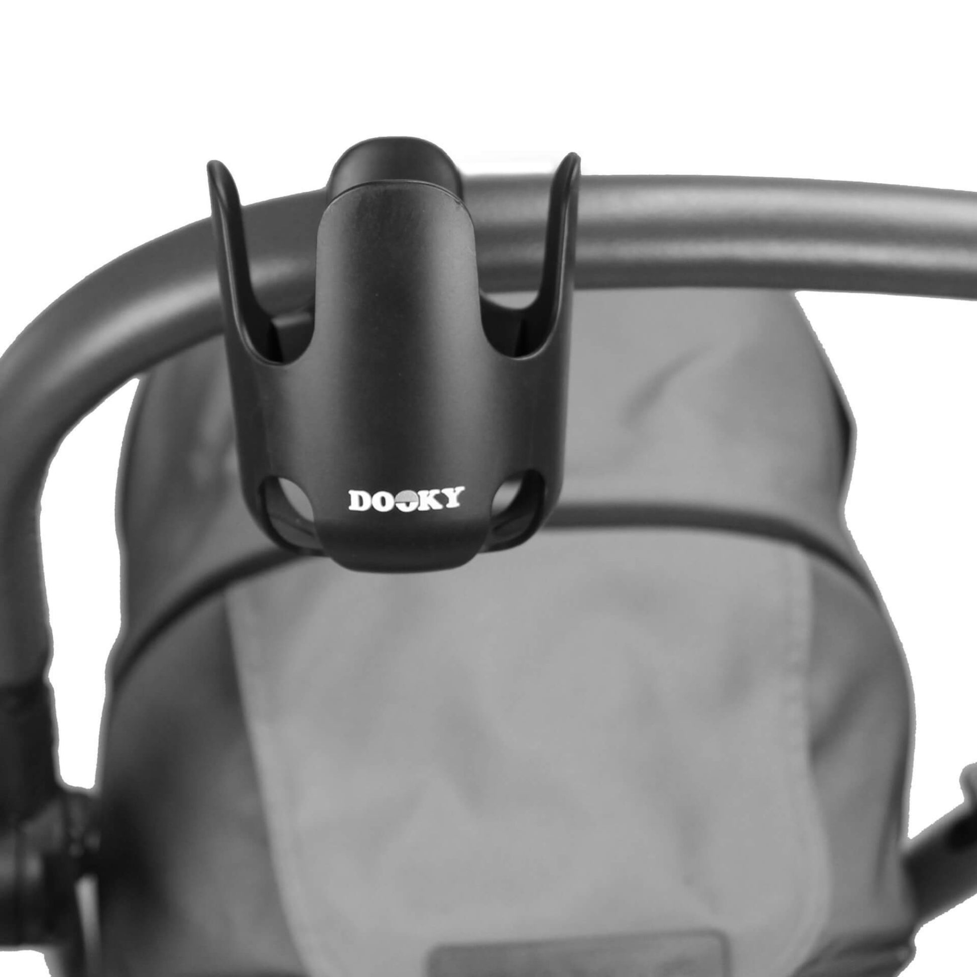 A front view of a black cup holder fixed to a stroller handlebar with a fabric canopy behind it.