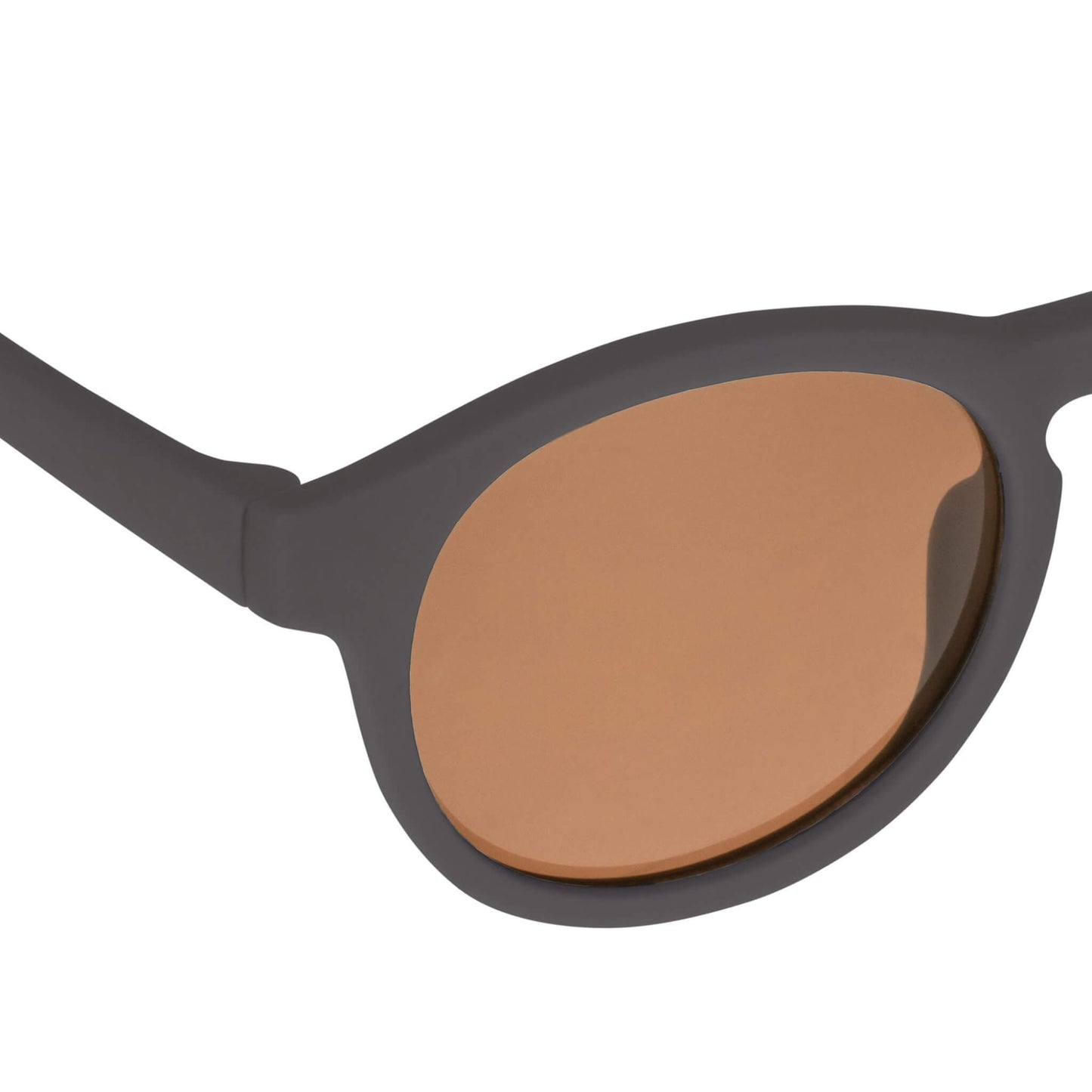Close-up view of a Falcon baby sunglasses lens showing scratch-resistant, anti-reflective brown coating.