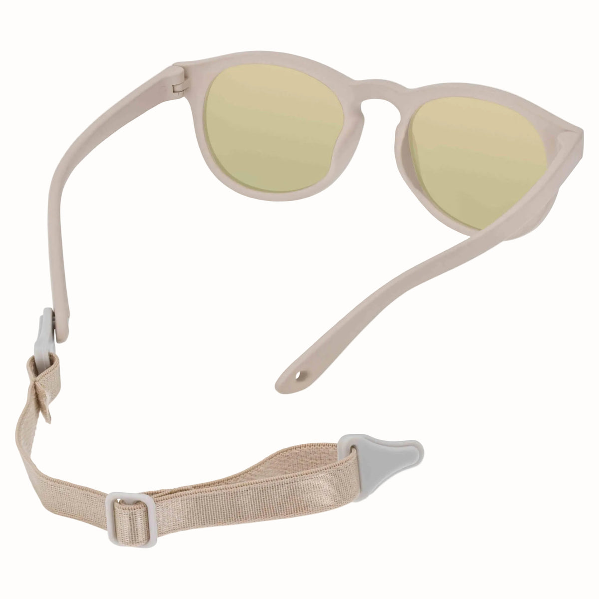 Beige children’s sunglasses with the adjustable fabric strap detached and shown behind the frames.