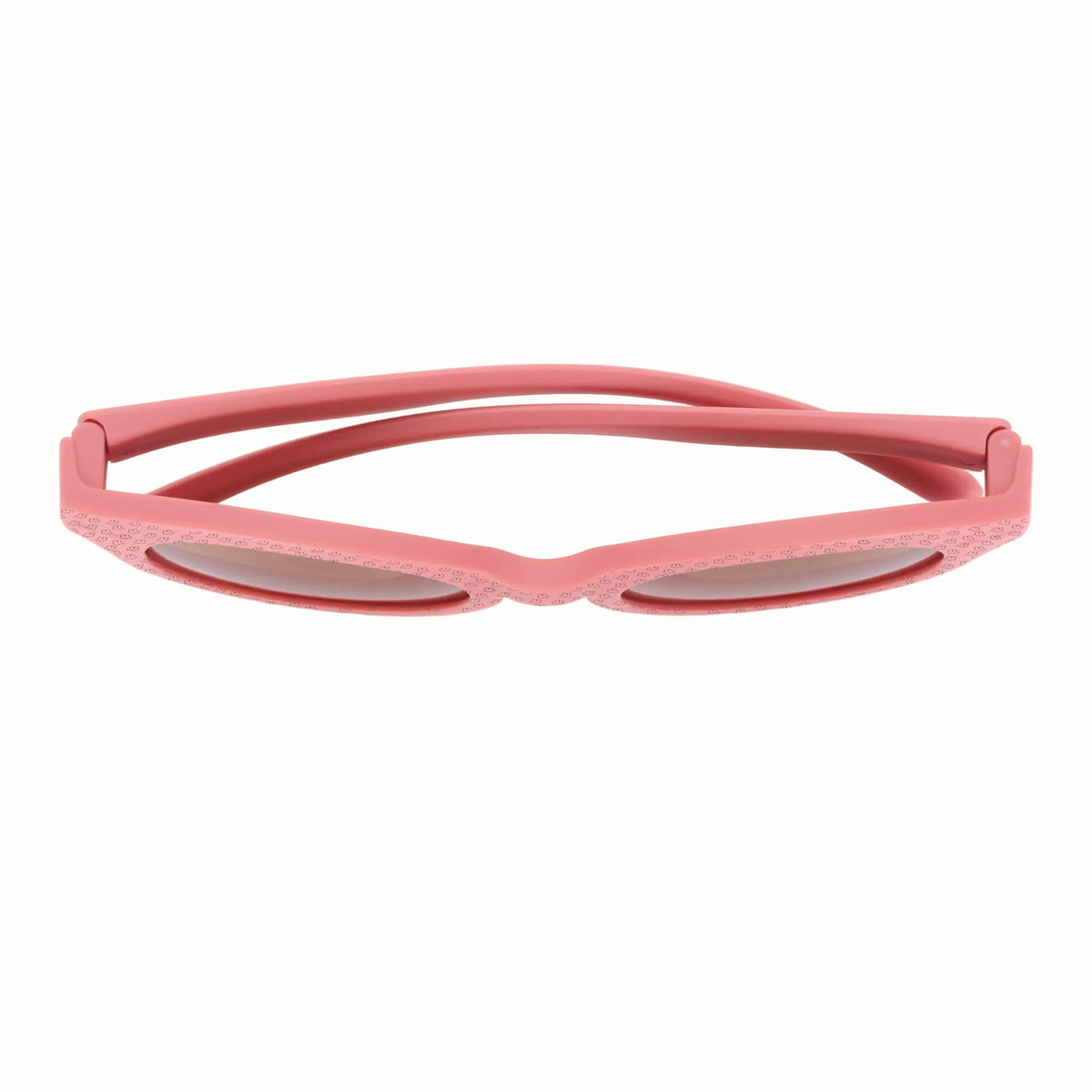 Top view of pink children’s sunglasses showing the curved arms, hinges and rounded frames.