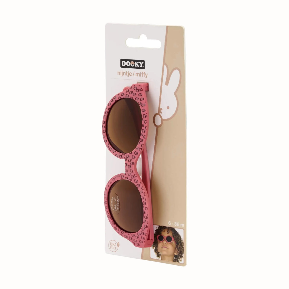 Pink children’s sunglasses displayed in Miffy packaging with brown lenses and patterned frames.