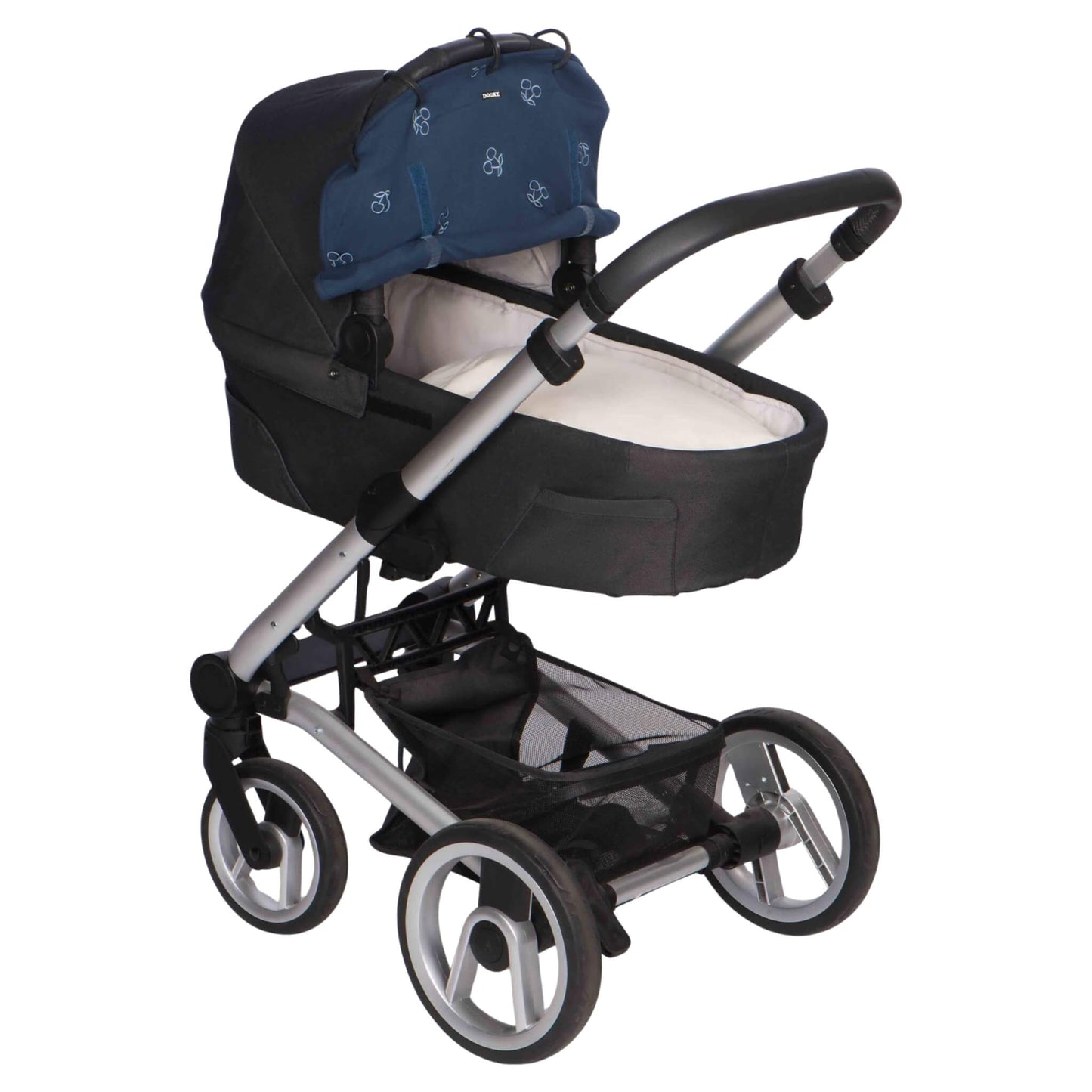 A blue cherry-patterned sunshade fitted to a carrycot-style pram, with the shade partially rolled up and clipped onto the hood using five rings.