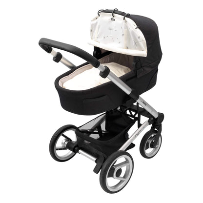A pram with black fabric and silver frame fitted with a dandelion-patterned sunshade. The cover is partially rolled up and clipped to the hood.