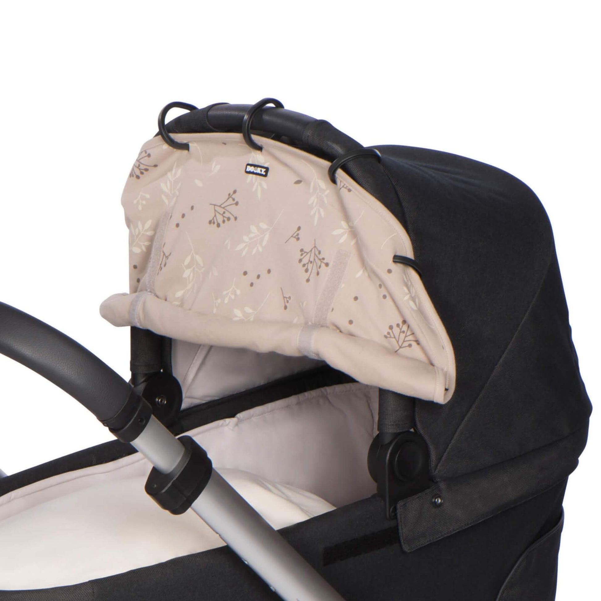 Dooky Sunshade in Romantic Leaves Beige attached to a pram canopy, showing the stylish neutral-toned print and universal clip-on design.
