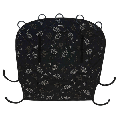 A Dooky Sunshade in Romantic Leaves Black displayed flat, showing its curved design with soft black fabric, delicate white and taupe leaf pattern, black ties at the corners, and five plastic attachment rings along the top edge.
