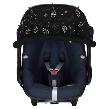 A dark baby car seat fitted with a black leaf-patterned sunshade secured along the canopy using five rings, with the lower edge softly gathered and velcroed at the sides.