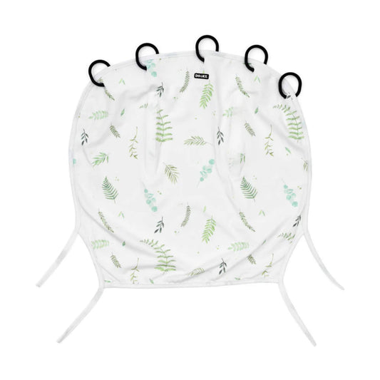Dooky Sunshade in Tuscany with soft green leaf print, laid flat to show the five black attachment rings along the top and two fabric ties at the bottom.