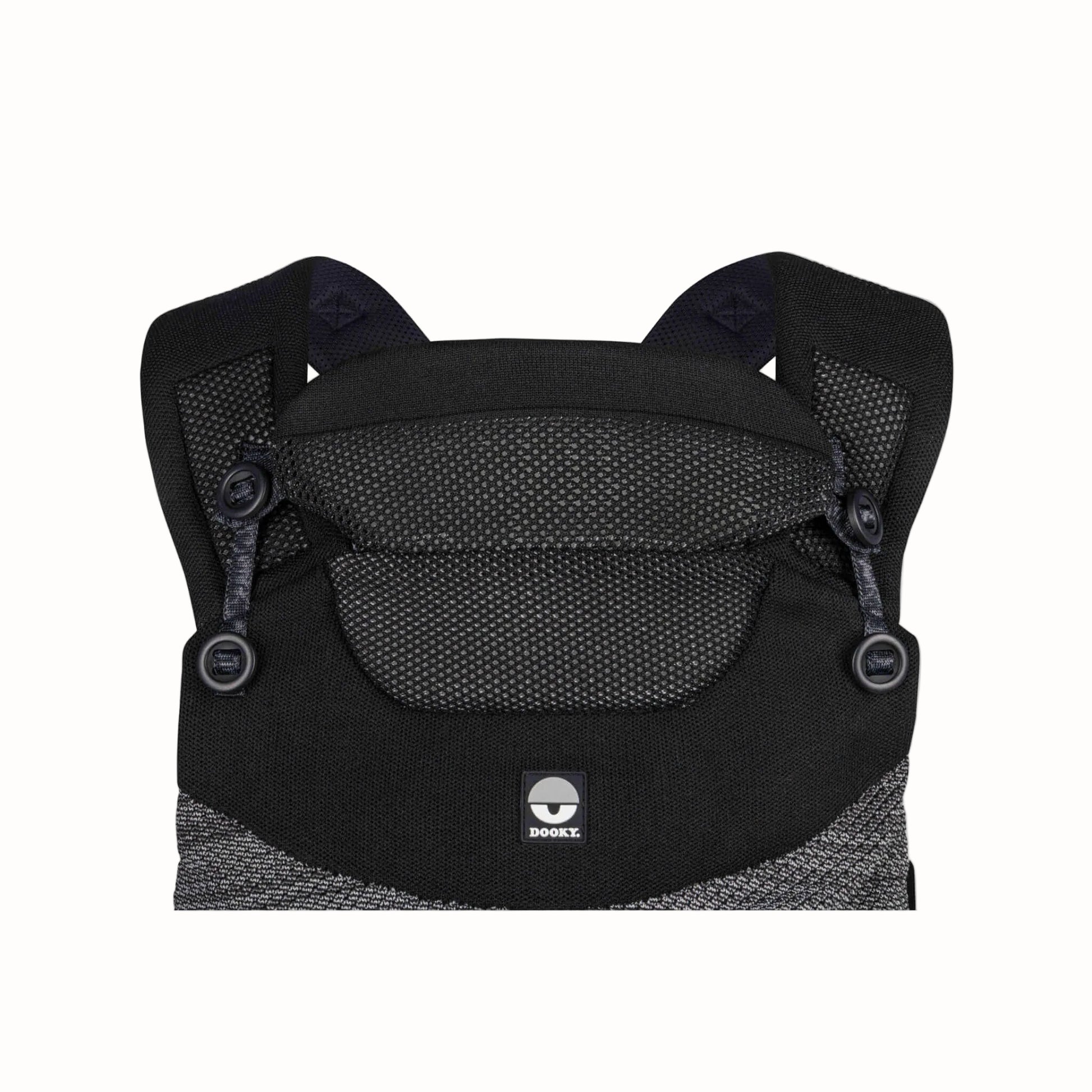 Close-up of a black baby carrier showing the breathable upper panel, adjustable head support and shoulder straps.