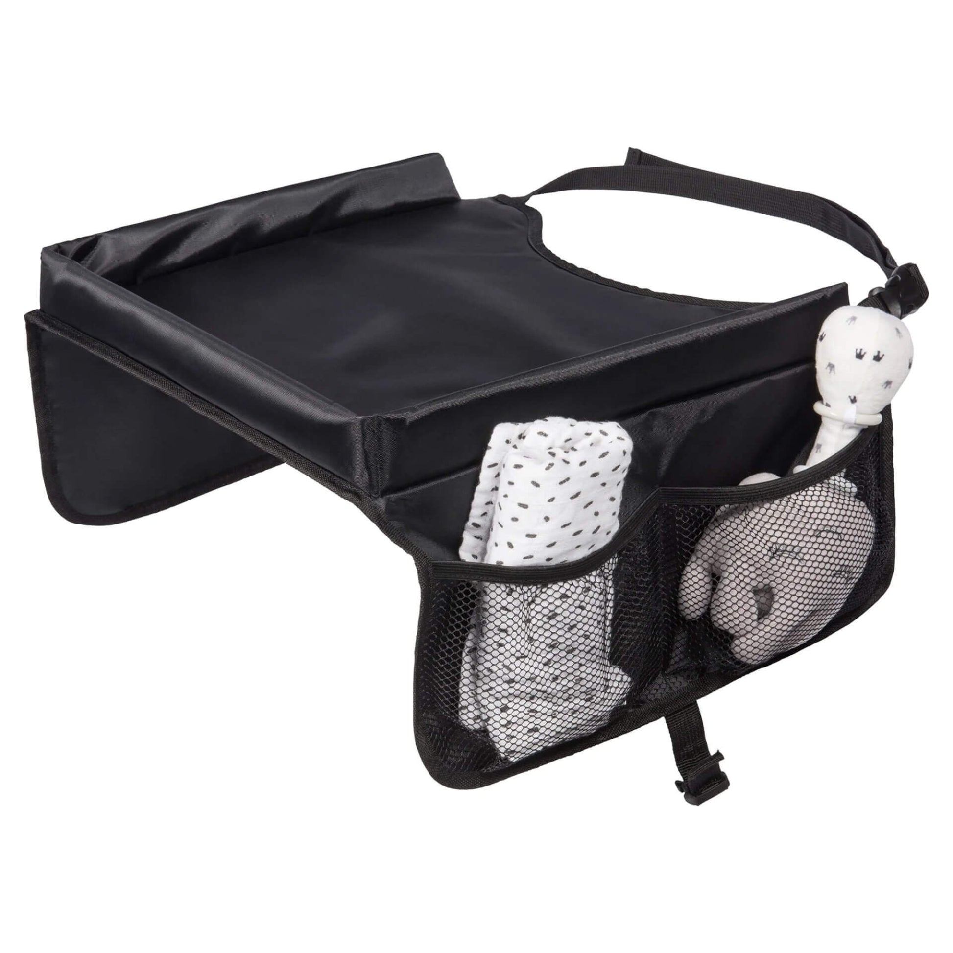  A black travel table with mesh side pockets holding a soft toy and a rolled muslin cloth.