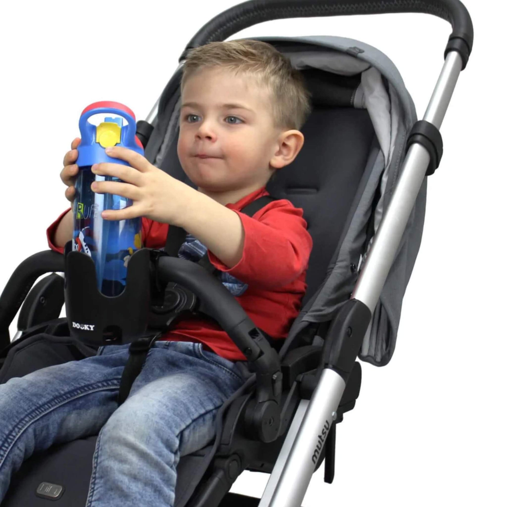 A young child in a stroller holding a blue drinks bottle placed inside a black cup holder attached to the stroller’s front bar.