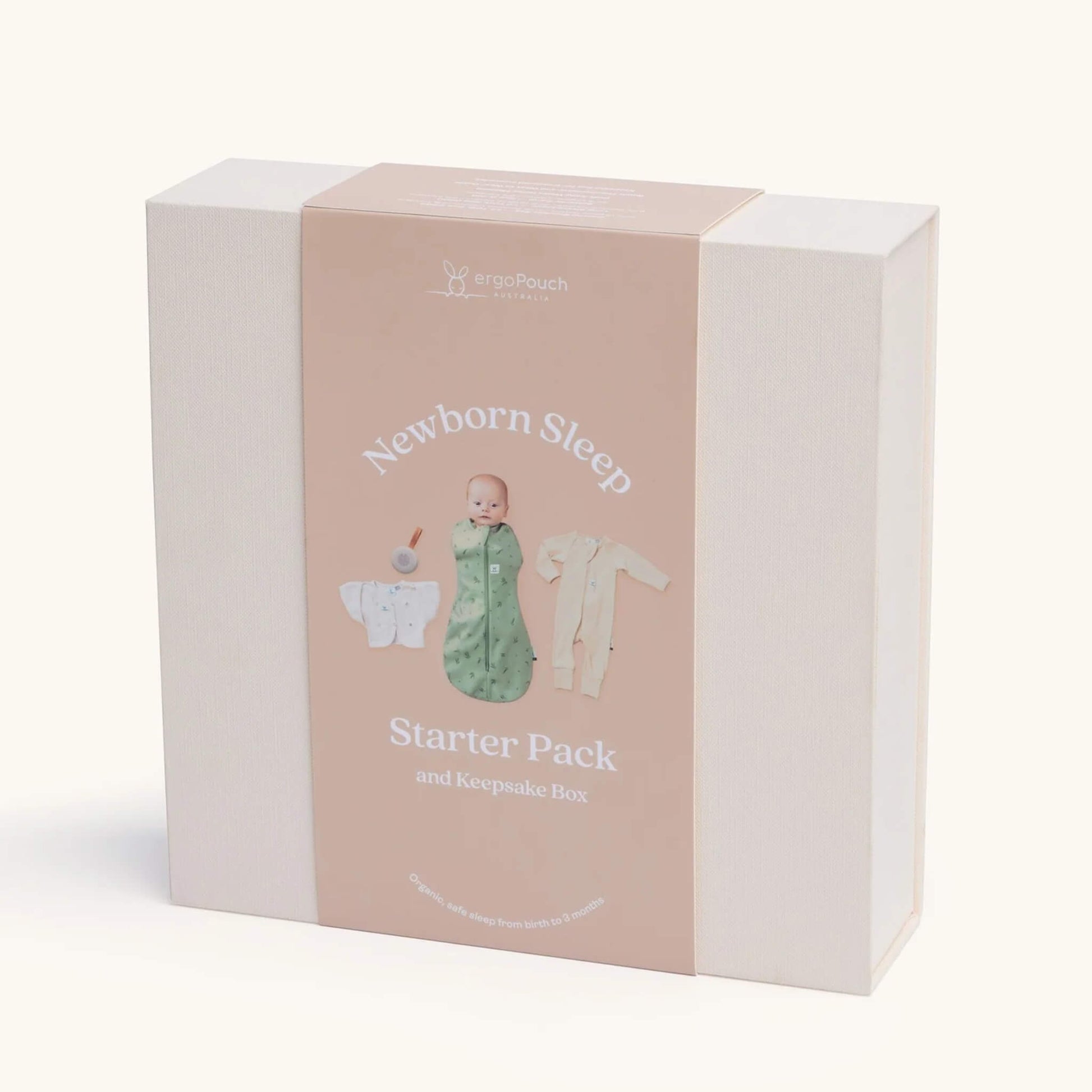 A cream keepsake gift box with a peach sleeve featuring a baby image and illustrations of the newborn sleep essentials inside.