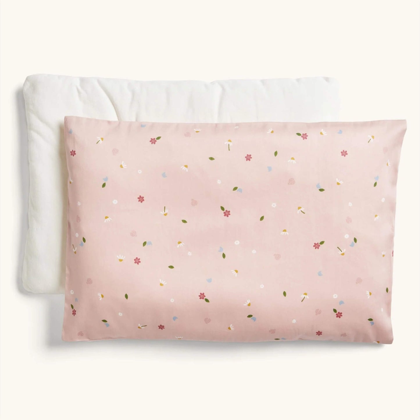 ErgoPouch Organic Toddler Pillow and Case in the Daisies print, showing a pink pillow with a delicate floral and leaf pattern, displayed with its insert.