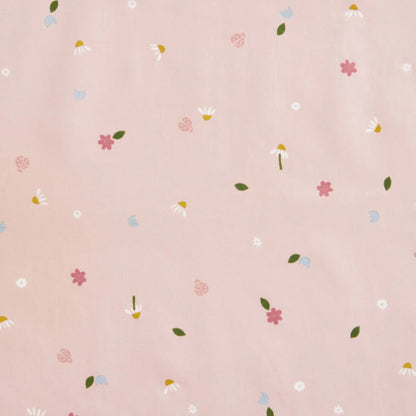 Close-up view of Daisies print fabric featuring pink, white, and blue flowers, green leaves, and tiny ladybirds on a soft pink background.