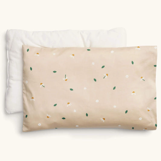 ErgoPouch Organic Toddler Pillow and Case in the Daisy Sprinkle print, showing a beige pillow with scattered white daisies and green leaves, displayed with its insert.