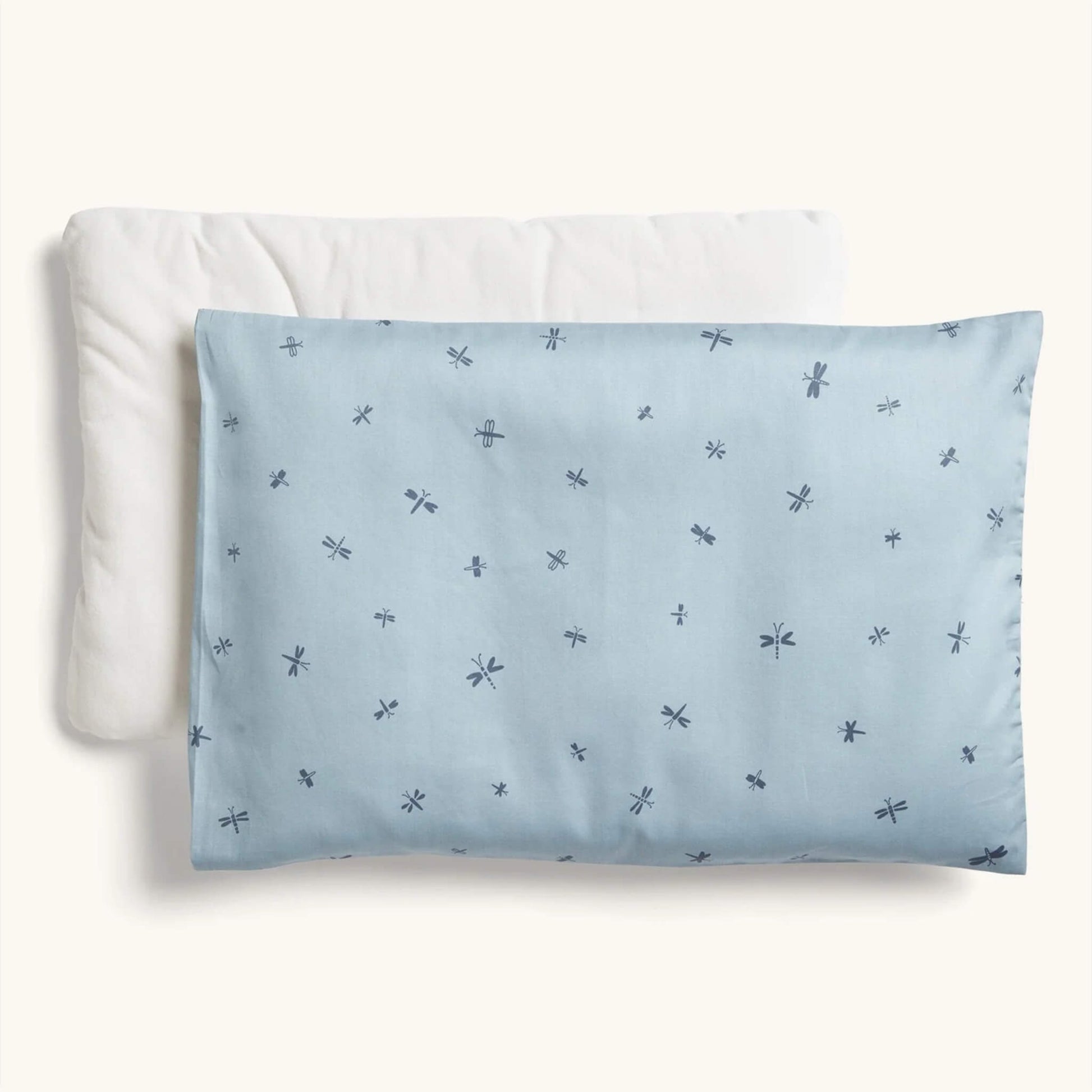 ErgoPouch Organic Toddler Pillow and Case in the Dragonflies print, featuring a light blue pillow with scattered navy dragonfly motifs, displayed with its insert.